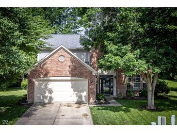 Charming two-story brick home with well-maintained lawn and mature trees at 3474 Glen Abbe Ct, Carmel, IN 46032