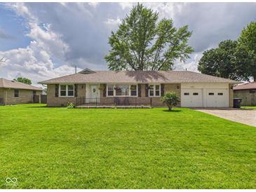 Charming single-story home with a lush green lawn and attached two car garage at 3809 N Glenwood Ave, Muncie, IN 47304