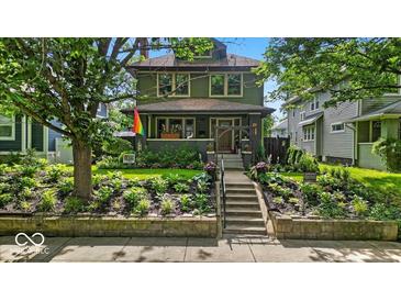 Charming two-story home with a beautifully landscaped front yard and welcoming front porch at 4046 N Park Ave, Indianapolis, IN 46205