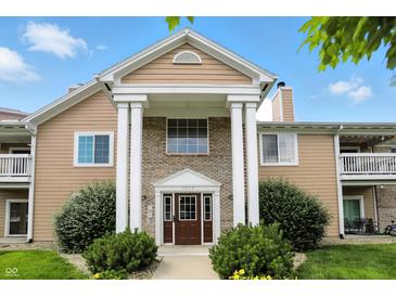 Inviting exterior featuring a well-maintained facade, beautiful landscaping, and covered entrance at 5003 Opal Ridge Ln # 101, Indianapolis, IN 46237