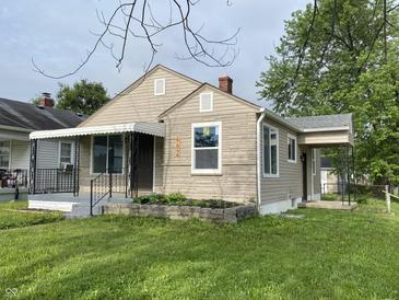 Charming single-Gathering home features a covered front porch, brick accents, and a well-manicured lawn at 602 S Sherman Dr, Indianapolis, IN 46203