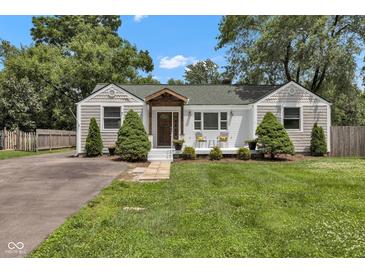 Charming home featuring classic architecture, a quaint front porch, and well-maintained landscaping at 6741 Evanston Ave, Indianapolis, IN 46220