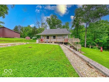 Charming single-story home featuring a quaint porch and well-manicured front lawn at 8635 S Providence Dr, Nineveh, IN 46164