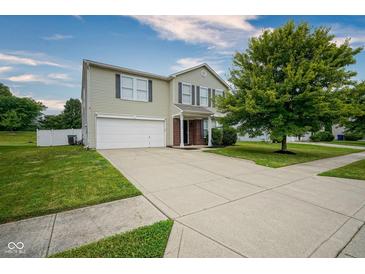 Inviting two-story home with a well-manicured lawn and an attached two-car garage at 9775 Big Bend Dr, Indianapolis, IN 46234