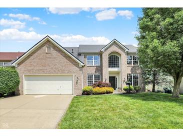 Beautiful two-story brick home featuring a manicured lawn and attached two-car garage at 13757 Flintridge Pass, Carmel, IN 46033