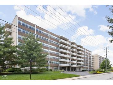 Spacious brick apartment building with balconies, well-maintained lawn, and mature trees at 25 E 40Th St # Apt 1B/D, Indianapolis, IN 46205