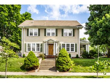 Charming two-story home with a well-maintained lawn and front porch leading to the front door at 4904 N Washington Blvd, Indianapolis, IN 46205