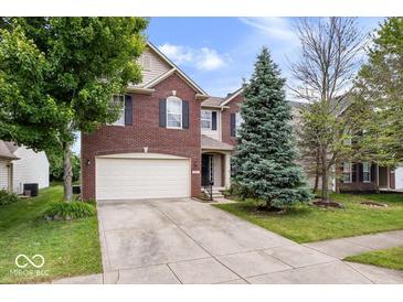 Charming two-story brick home with a well-maintained lawn and mature trees at 8877 N White Tail Trl, McCordsville, IN 46055