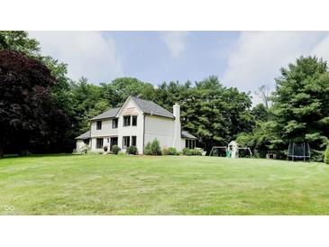 Charming two-story home with a well-manicured lawn and mature trees, perfect for outdoor enjoyment at 9710 Iroquois Ct, Indianapolis, IN 46256
