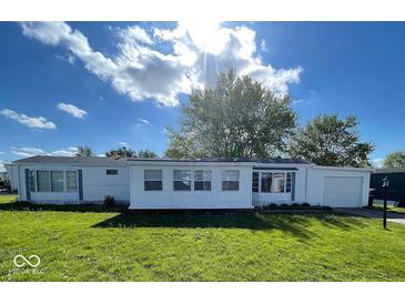 Charming single-story home featuring a well-maintained lawn and an attached garage at 10 Lincoln Cir, Elwood, IN 46036