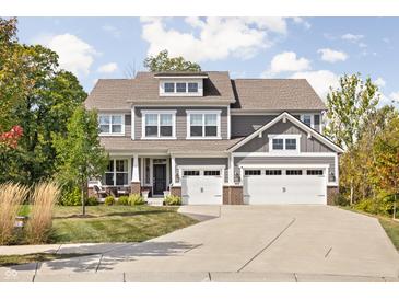 Beautiful two-story home featuring a three-car garage, dormer, manicured lawn, and inviting curb appeal at 10262 Rieslaner Cir, Zionsville, IN 46077