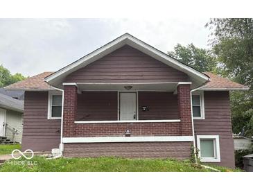 Charming brown exterior showcasing the home's covered porch and classic architectural style at 1521 N Tacoma Ave, Indianapolis, IN 46201