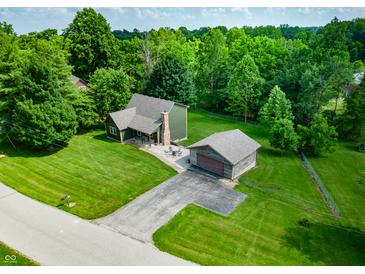 Lovely home featuring mature trees, a detached garage, and well-maintained landscaping at 155 Hoover Dr, , IN 46164