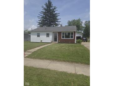 Charming ranch-style home featuring a well-maintained lawn, inviting curb appeal, and tidy landscaping at 206 Allen Ln, Greenfield, IN 46140