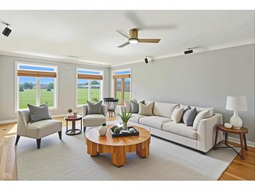Bright living room with a fan, plush seating, large windows, and a view of the outdoors at 2251 Somerset Dr, Franklin, IN 46131