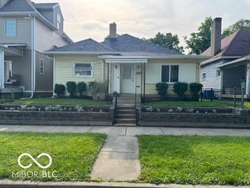 Charming one-story home featuring a landscaped yard and inviting front porch at 2830 Guilford Ave, Indianapolis, IN 46205
