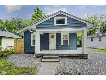 Charming blue house with a welcoming front porch and well-maintained landscaping at 3562 E Morris St, Indianapolis, IN 46203