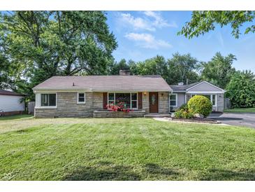 Charming single-story home featuring stone facade, flower beds, and well-manicured lawn at 5170 Mt Pleasant N St, Greenwood, IN 46142