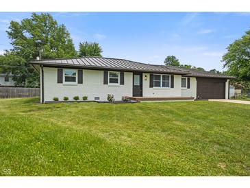 Exterior view of charming home with well-maintained lawn, mature trees, and updated roof at 6609 Cordova Ct, Indianapolis, IN 46221