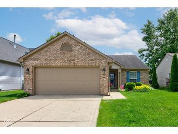 Charming single-story brick home with a two-car garage, manicured lawn, and a welcoming garden at 741 Chestnut Ln, Brownsburg, IN 46112