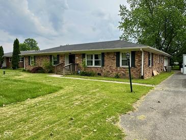 Charming brick ranch with well-maintained lawn and classic black shutters at 8061 Sycamore Springs Trl, Indianapolis, IN 46239