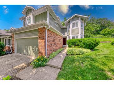 Inviting two-story home featuring a brick facade, attached garage, and well-maintained landscaping at 8178 Foxchase Cir, Indianapolis, IN 46256