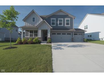 Charming two-story home featuring a well-manicured lawn and a spacious two-car garage at 11663 Winnower, Noblesville, IN 46060