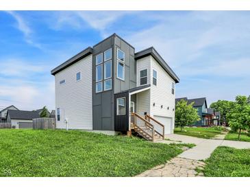 Contemporary two-story home featuring a unique facade, wooden stairs, and landscaped lawn at 2008 Yandes St, Indianapolis, IN 46202