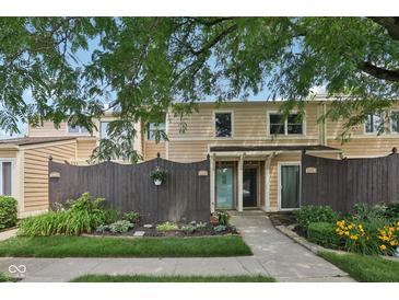 Inviting townhome featuring a well-maintained front yard and a charming fence at 5152 Coppertree Ln, Avon, IN 46123