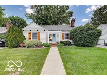 Charming single-story home with manicured lawn and inviting front porch at 5363 Primrose Ave, Indianapolis, IN 46220