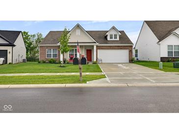Charming single-Gathering home featuring a brick facade, well-manicured lawn, and an attached two-car garage at 9858 Bryce Blvd, Pendleton, IN 46064
