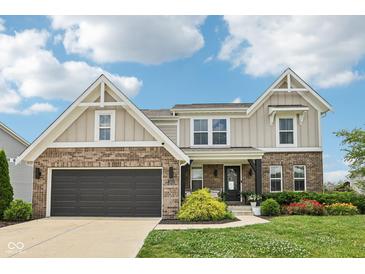 Charming two-story home with a brick and siding exterior and well-manicured lawn, showcasing curb appeal at 1414 W Springhurst Blvd, Greenfield, IN 46140