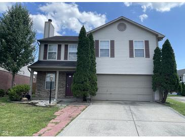 Charming two-story home features a two-car garage, brick accents, and manicured landscaping at 1503 Quinlan Ct, Indianapolis, IN 46217