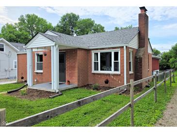 Charming brick home featuring a cozy front porch and well-maintained landscaping at 160 E Elm St, Morgantown, IN 46160