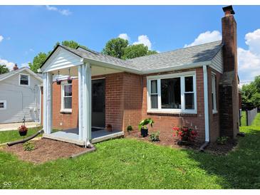 Charming brick home featuring a covered front porch, well-maintained lawn, and mature landscaping, offering inviting curb appeal at 160 E Elm St, Morgantown, IN 46160