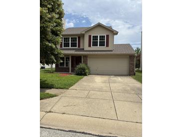 Charming two-story home featuring red shutters, a two car garage, and a concrete driveway at 19236 Fox Chase Dr, Noblesville, IN 46062