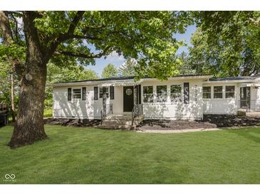 Charming single-story home featuring a well-manicured lawn and inviting front entrance with a stately tree at 20797 Roberts Dr, Sheridan, IN 46069