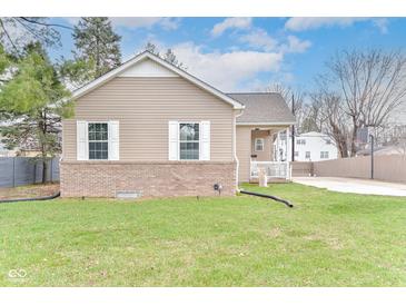 Charming home featuring vinyl siding, brick accents, well-manicured lawn, and white window shutters at 3147 Bonham Dr, Indianapolis, IN 46222