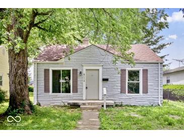 Charming single-story home with stone facade, mature trees, and a cozy front porch at 4034 N Temple Ave, Indianapolis, IN 46205