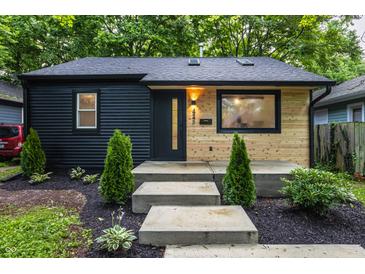 Charming home featuring a dark wood facade and a light wood accent wall creating a modern look at 4245 Norwaldo Ave, Indianapolis, IN 46205