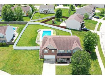 Stunning aerial view of home with a pool, fenced yard, and well-manicured lawn at 5063 Haywood Ln, Plainfield, IN 46168