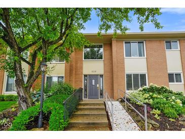 Charming brick condo exterior with well-maintained landscaping and accessible ramp to the front door at 526 W Hunters Dr # C, Carmel, IN 46032