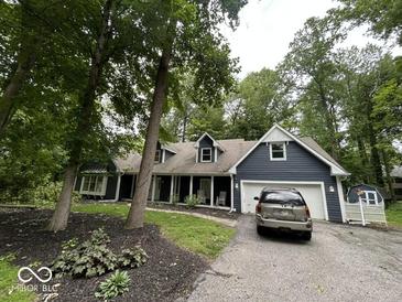 Charming home features a two car garage, mature trees, and a cozy front porch at 8407 Campbell Ct, Mooresville, IN 46158