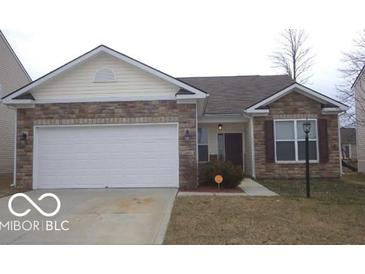 Charming single-story home featuring a brick facade, attached garage, and well-maintained lawn at 12451 Cricket Song Ln, Noblesville, IN 46060