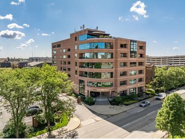 Stunning exterior view of building with blue tinted windows on a sunny day at 225 N New Jersey St # 52, Indianapolis, IN 46204