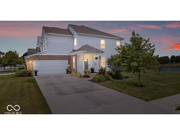 Charming two-story home with white siding, brick accents, and a well-manicured front yard at dusk at 2499 Blue Ridge Dr, Greenwood, IN 46143