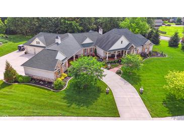 Expansive home with lush landscaping, long driveway, and three-car garage at 3399 Nottinghill Blvd, Plainfield, IN 46168