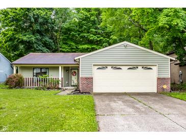 Charming single-story home with a well-manicured lawn and an attached two-car garage at 4309 Clayburn Dr, Indianapolis, IN 46268