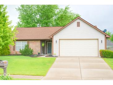 Charming single-story home with a well-manicured lawn and a two-car garage at 444 Austin Dr, Avon, IN 46123