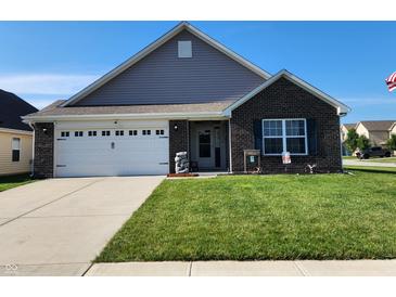 Charming single-Gathering home with a well-manicured lawn, brick facade, and a two-car garage in a suburban neighborhood at 7511 Eddie Ln, Camby, IN 46113